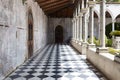 Walkway path with checkered pattern marble tiles floor and shadow from outside sunlight in old gothic church Royalty Free Stock Photo
