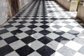 Walkway path with checkered pattern marble tiles floor and shadow from outside sunlight in old gothic church Royalty Free Stock Photo