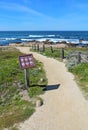 Walkway and sign for Asilomar State beach in Pacific Grove, Cali