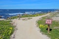 Walkway and sign for Asilomar State beach in Pacific Grove, Cali