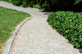 A walkway of square stone tiles with a granite curb for walking. Royalty Free Stock Photo