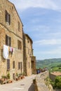 Walkway and a terrace with people in Pienza, Italy