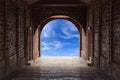 Walkway tunnel made by red brick and view of blue sky Royalty Free Stock Photo