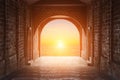 Walkway tunnel made by red brick and view of sunset or sunrise Royalty Free Stock Photo