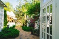 walkway between white glazed gazebos in the park. Landscaping.