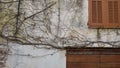 The wall of the abandoned house with closed windows and gates wa