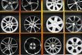 Wall of alloy car wheels and pneumatic tires in store. seasonal wheel storage Royalty Free Stock Photo