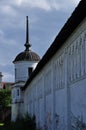 The wall of an ancient monastery with a corner tower. Royalty Free Stock Photo