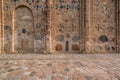 wall of an ancient orthodox church, monument of old brick russian architecture with texture of clay brick, decorated with inserts