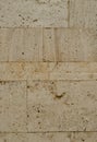 A wall from an artificial gray stone facade with rough fractured surfaces