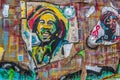 A wall with artistic message and symbolic image of Bob Marley