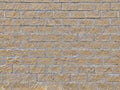 Wall background of light brown brick. The rough masonry of sand stone. Brick texture of sandy color limestone Royalty Free Stock Photo