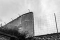 Wall and barbwire at a concentration camp- Black and White