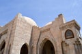 A wall with a beautiful texture of a Muslim Islamic Arab mosque made of white brick architecture with arches, tall towers, domes a Royalty Free Stock Photo