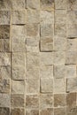 Wall of beige square stone blocks