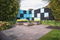 Wall with black and blue surfaces with modern garden furniture in front