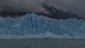 A wall of blue cracked ice rises above a turquoise lake. Royalty Free Stock Photo