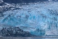 Wall of blue ice of a glacier ending in the sea Royalty Free Stock Photo
