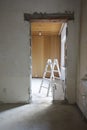 Wall breakthrough for a room door, behind it a painter\'s ladder