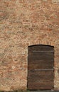 Wall of bricks and an old wooden door