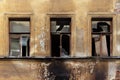 Wall with broken windows. abandoned apartment building after a fire