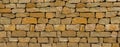 Wall of brown old cobblestones background solid, stone Royalty Free Stock Photo