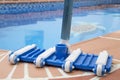 Wall Brush and Leaf Skimmer Maintenance Tools on Deck Beside Swimming Pool Royalty Free Stock Photo