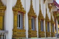 Wall of Buddhist temple with richly decorated windows Royalty Free Stock Photo