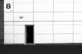 The wall of the building, the door and the CCTV camera. Black and white background. Royalty Free Stock Photo