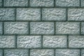 The wall of the building is made of concrete blocks. Aged blue and green tinted background or wallpaper. The seams form pattern