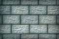 The wall of the building is made of concrete blocks. Aged blue and green tinted background or wallpaper with vignetting. Masonry