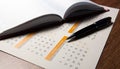 Wall calendar with pen and diary closeup Royalty Free Stock Photo