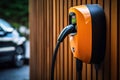 Wall charger for electric car, charging station outside home close-up Royalty Free Stock Photo