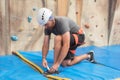 Wall climber putting on climbing shoes