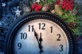 Wall clock in Christmas or New Year decorations are wrapped with fir branches and Christmas decorations. On the clock Royalty Free Stock Photo