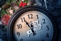 Wall clock in Christmas or New Year decorations are wrapped with fir branches and Christmas decorations. On the clock Royalty Free Stock Photo