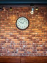 The wall clock hangs on a red-brick wall Royalty Free Stock Photo