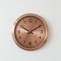 Wall clock with a round copper-colored frame and a brushed metallic finish. The cloc Royalty Free Stock Photo