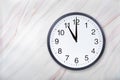 Wall clock show eleven o`clock on marble texture. Office clock show 11pm or 11am