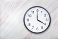 Wall clock show four o`clock on marble texture. Office clock show 4pm or 4am Royalty Free Stock Photo