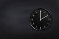 Wall clock showing two o`clock on black chalkboard background. Office clock showing 2am or 2pm on black texture Royalty Free Stock Photo