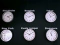 Wall Clocks Showing Different Time of Many Cities in the World on Black Wall Background