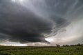 A wall cloud forms underneath a supercell storm, over fields of sagebrush. Royalty Free Stock Photo