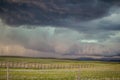 A wall cloud with a long tail cloud forms under a supercell storm in the high plains. Royalty Free Stock Photo