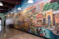 wall of colorful murals, depicting different scenes from around the world