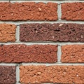 Wall composed of rectangular, rough-textured bricks in varying Royalty Free Stock Photo