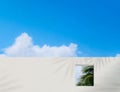 Wall concrete texture with open window and coconut palm leaves against blue sky and clouds,Exterior White paint cement building, Royalty Free Stock Photo