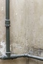 On the wall in a corner is an old heating pipes, without a radiator. Royalty Free Stock Photo