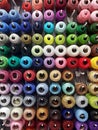 Wall of cotton reels, lots of colorful spools of thread displayed at the notions store, many sewing accessories for art and crafts Royalty Free Stock Photo