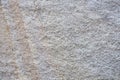 Wall is covered with decorative marble crumbs. White, gray and brown marble blotches of stone on the insulated facade of Royalty Free Stock Photo